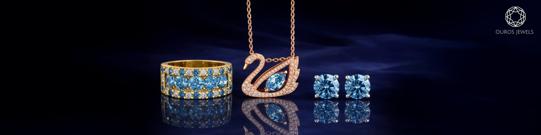 Blue diamond jewelry set featuring gold ring with white diamonds, rose gold swan pendant necklace, and round brilliant cut blue diamond stud earrings