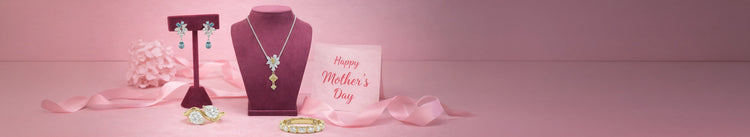 Ouros Jewels Ready To Ship Mother's Day Jewelry Collection offering lab grown diamond earrings, necklace, rings, and bracelet displayed on burgundy velvet stands with pink ribbon