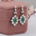 Green Emerald And Princess Diamond Halo Earrings Earrings